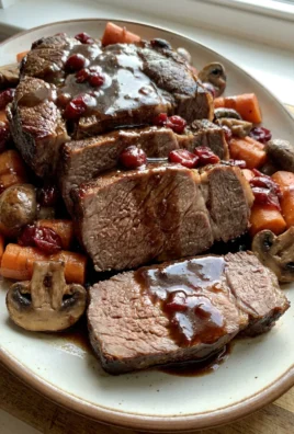 A white platter holding sliced cranberry balsamic pot roast with a serving fork.