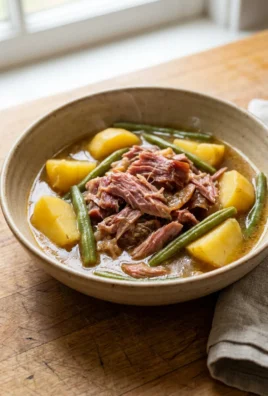 Overhead view of a finished bowl of crockpot ham and vegetables.