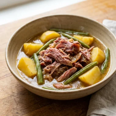 Overhead view of a finished bowl of crockpot ham and vegetables.